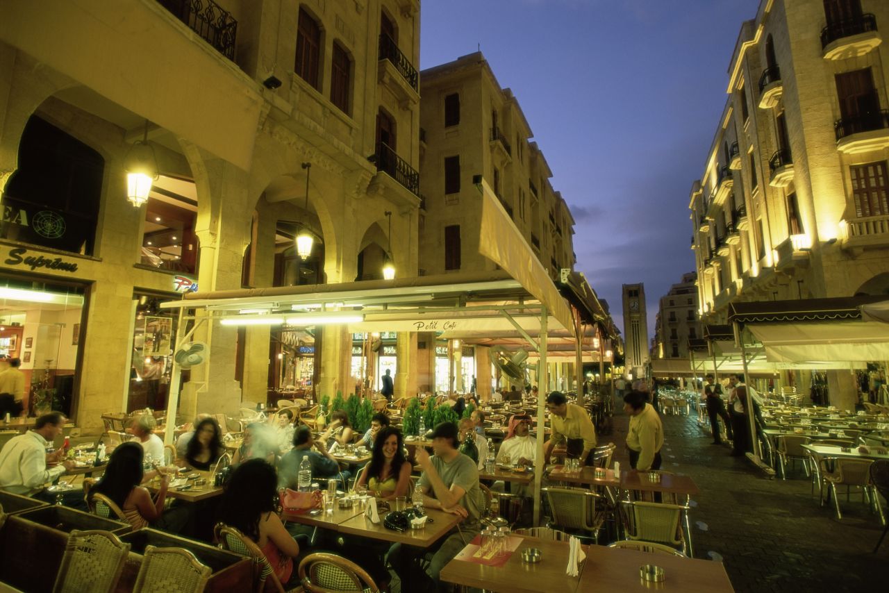 A row of outdoor restaurants in Beirut. Packed with family-style restaurants and street stalls, the capital is a good place to start.