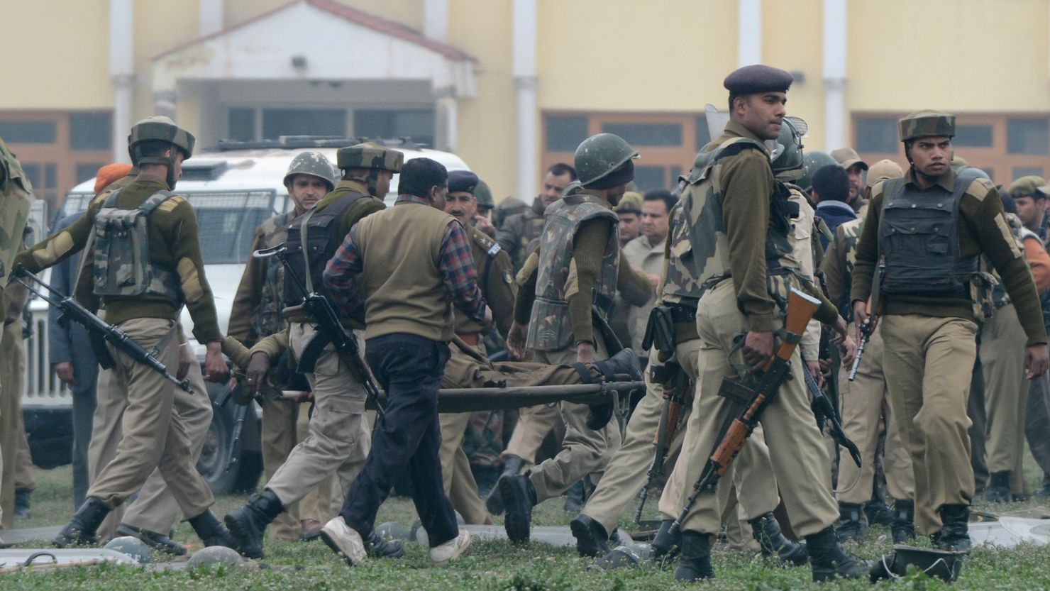 Indian paramilitary personnel carry away a fallen comrade in Srinagar on Wednesday. Five Indian officers died at the police camp.