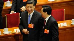 Chinese President Hu Jintao (R) chats with Vice President Xi Jinping as they make their way out after the opening session of the Chinese National People's Congress (NPC) at the Great Hall of the People in Beijing on March 5, 2013. Chinese Premier Wen Jiabao on March 5 targeted 2013 growth of 7.5 percent and vowed an unwavering fight against corruption as the world's second-largest economy opened its annual parliamentary session. 