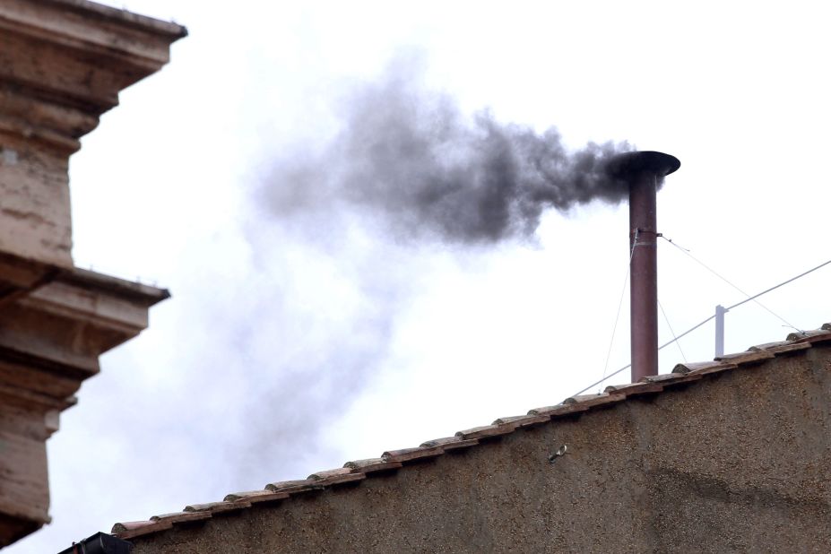 Black smoke billows from the chimney, indicating that the College of Cardinals has failed to elect a new pope on March 13. 