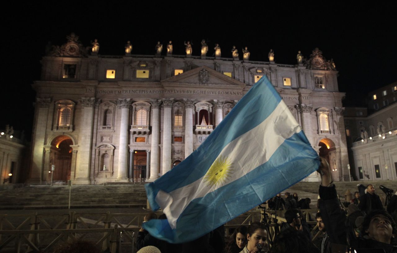People in St. Peter's Square wave Argentina's flag after the new pope was chosen.