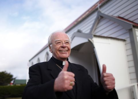 Catholic Monsignor Michael McPartland gestures his approval outside St. Mary's church after learning of newly elected Pope Francis in Stanley, Falkland Islands.