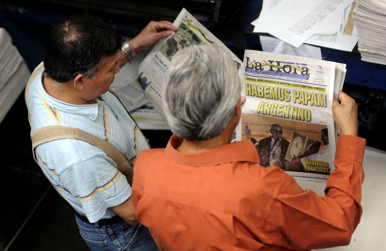 Employees of the evening newspaper La Hora in Guatemala City, Guatemala, review printed editions with the announcement of the election of Pope Francis.