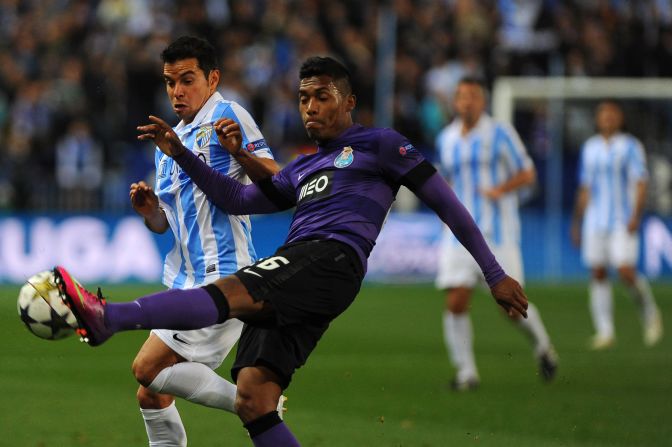 Malaga's Javier Saviola goes up against Porto's Alex Sandro with the Spanish club aiming to overturn a one-goal deficit from the first leg.