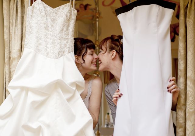 Creating contrast with two white dresses can be challenging without a dash of color to break the lines, co-author Thea Dodd said. Sometimes, the point can be made even if the brides aren't wearing them.