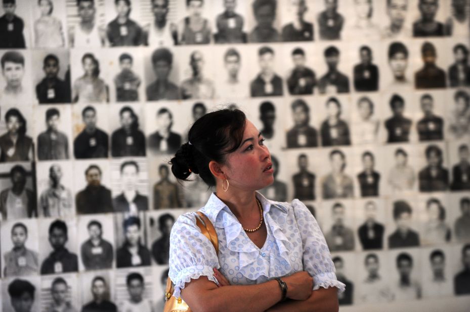 A Cambodian woman looks at portraits of victims of the Khmer Rouge at the Tuol Sleng genocide museum in Phnom Penh on November 17, 2011.