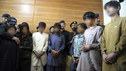 Pakistani police with young children, suspected of planting bombs, in Quetta on March 13, 2013.