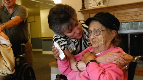 A massage therapist embraces a terminally ill patient at a Colorado hospice. 