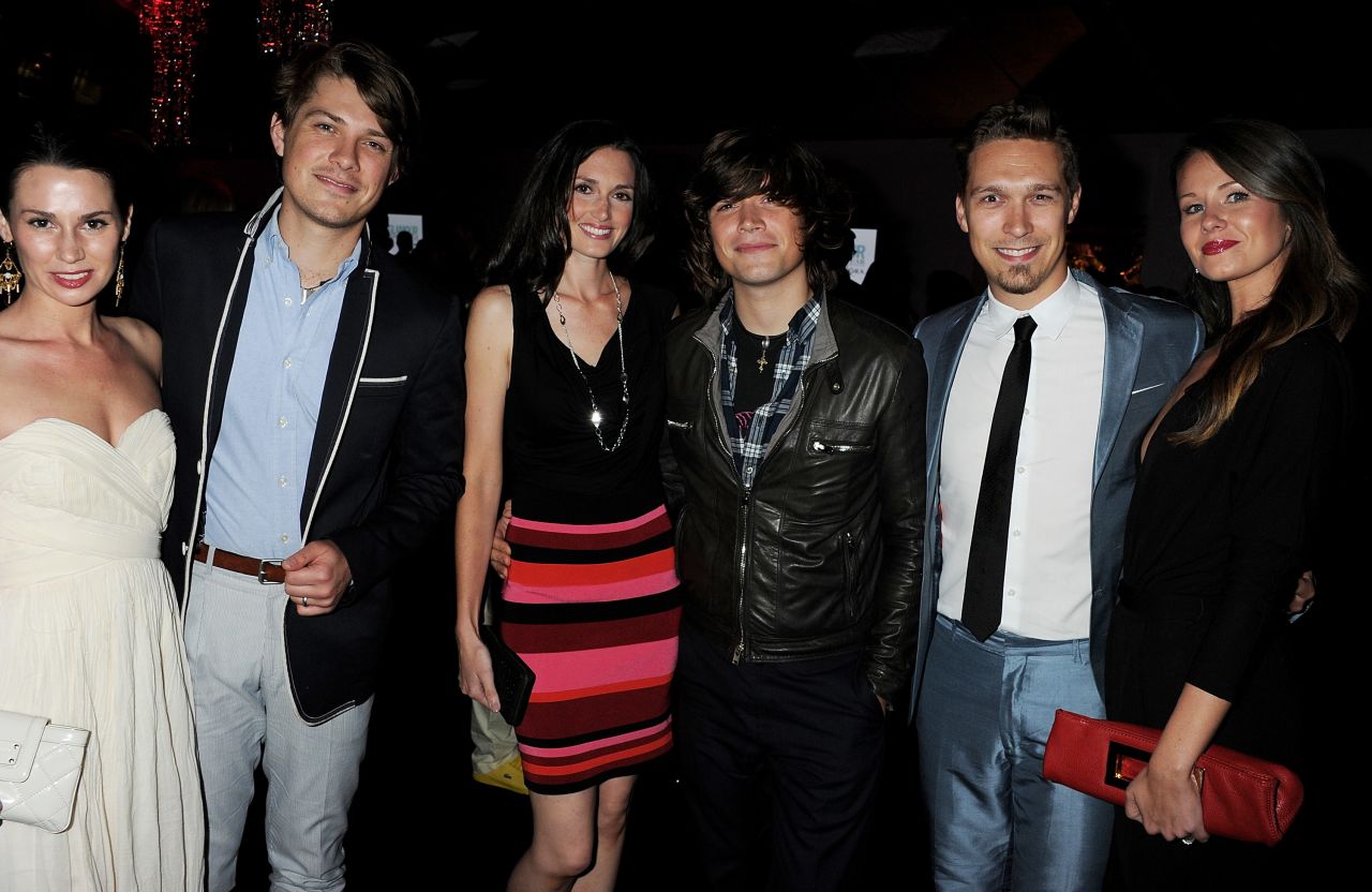 The brothers attend a party with their wives -- Natalie, left, Kate, center, and Nicole -- in London in 2011.