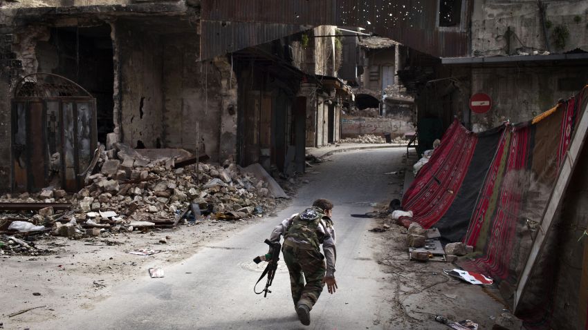 A Syrian rebel crosses a street while trying to dodge sniper fire in the old city of Aleppo in northern Syria on March 11, 2013. Syria warned on March 12 it is ready to fight 'for years' against rebels, as world powers worked on a new initiative to find regime officials suitable for peace talks with the opposition. 