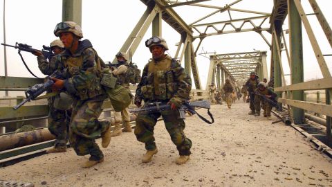 Members of the 3rd Battalion, 4th Marines, storm Diyala Bridge in Baghdad on April 7, 2003. 