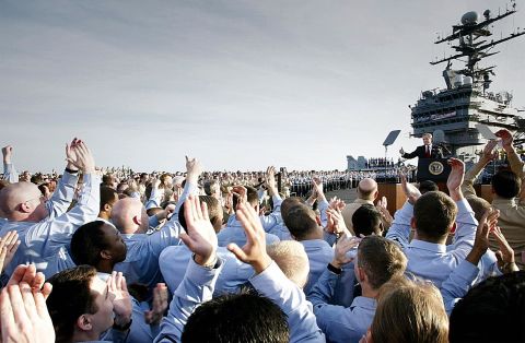 Sailors applaud as President Bush addresses the nation aboard the USS Abraham Lincoln on May 1, 2003. Standing beneath a banner that read "Mission Accomplished," the president declared major fighting over in Iraq and called it a victory in the ongoing war on terrorism.
