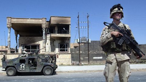 U.S. Army 101st Airborne troops investigate a house where Saddam Hussein's sons Uday and Qusay were killed in Mosul, Iraq, on July 23, 2003. The house, in an affluent neighborhood, was the scene of a fierce gunbattle.