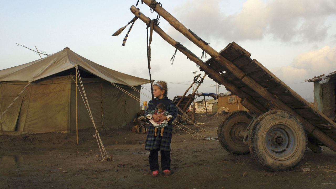 Eman Mohammed, 7, stands in the Kurdish refugee camp in Kirkuk on January 7, 2004. Since 2003, thousands of internally displaced Kurds have returned to Kirkuk.