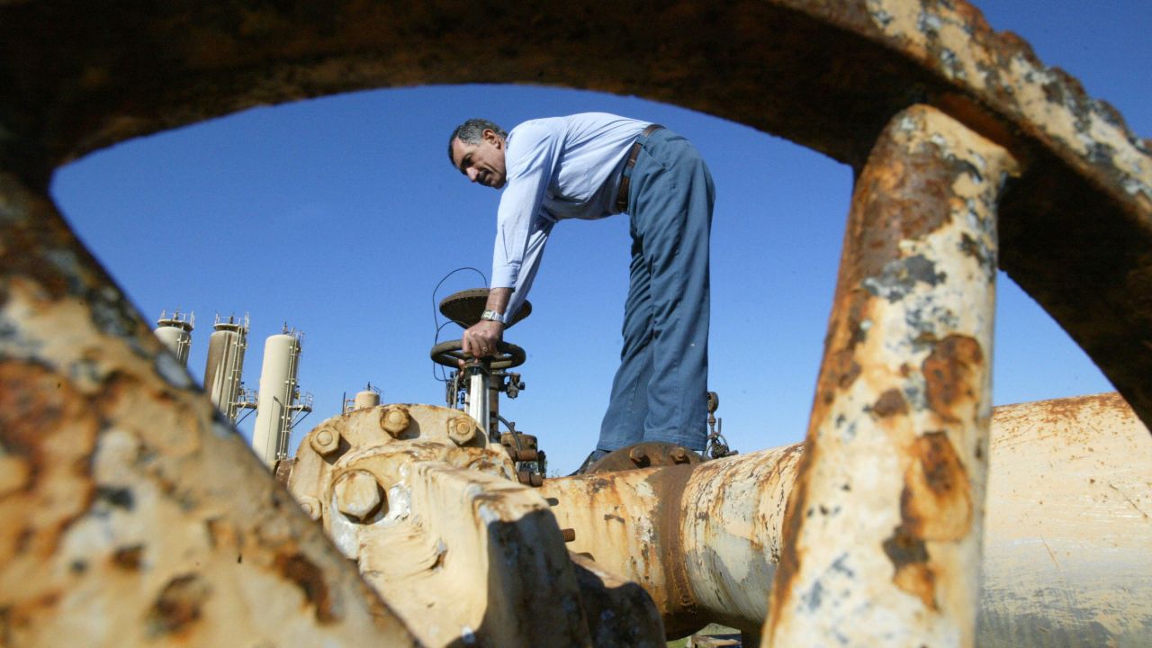 A worker turns a valve at the Shirawa oil field outside the northern city of Kirkuk on January 19, 2004. The security of Iraq's oil infrastructure had improved, but exports through the region's main pipeline had yet to resume.