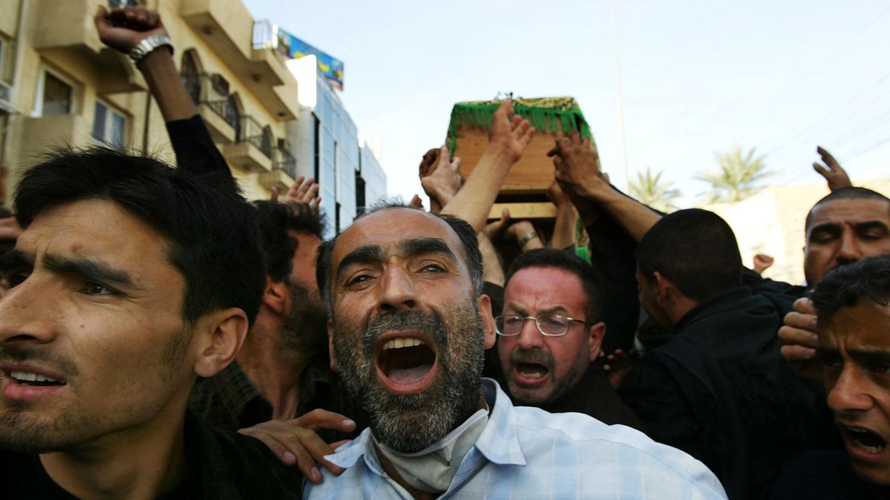 Mourners carry coffins in Karbala on March 3, 2004. A day after a series of bombs killed dozens and injured hundreds during the Ashura ceremony in the Shiite holy city of Karbala, Shiite Muslims began burying their dead.