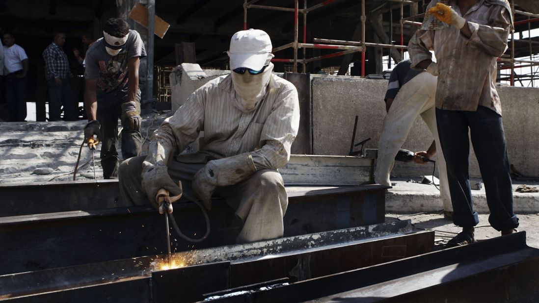 Construction workers weld beams at the Ministry of Transportation building in Baghdad on July 21, 2004. The building was being rebuilt after it was gutted by a fire.