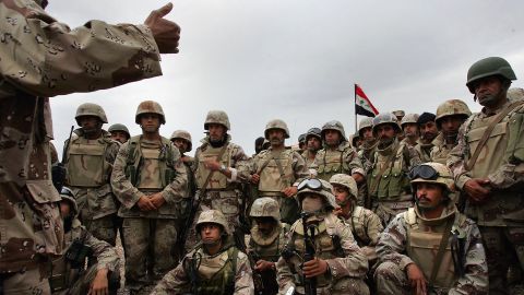 Members of the Iraqi Intervention Forces listen to last-minute instructions before heading out with U.S. troops to begin a major offensive on the insurgent stronghold of Fallujah on November 8, 2004.