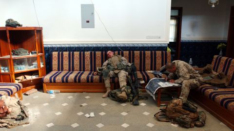 Marines rest and check a map in a house during an offensive in Fallujah on November 11, 2004.