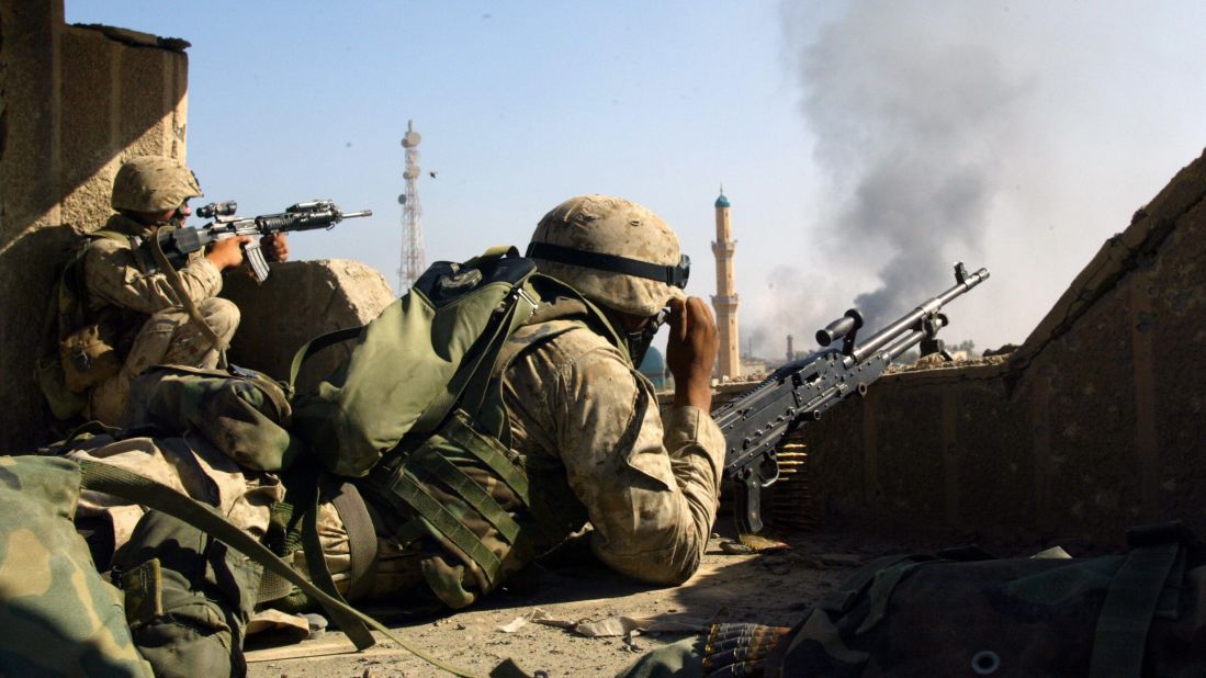 Marines take position on a roof in the restive city of Fallujah on November 13, 2004.