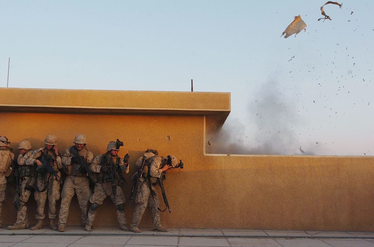 Marines use explosives to open rooftop doors while searching houses in Fallujah for insurgents on November 22, 2004.