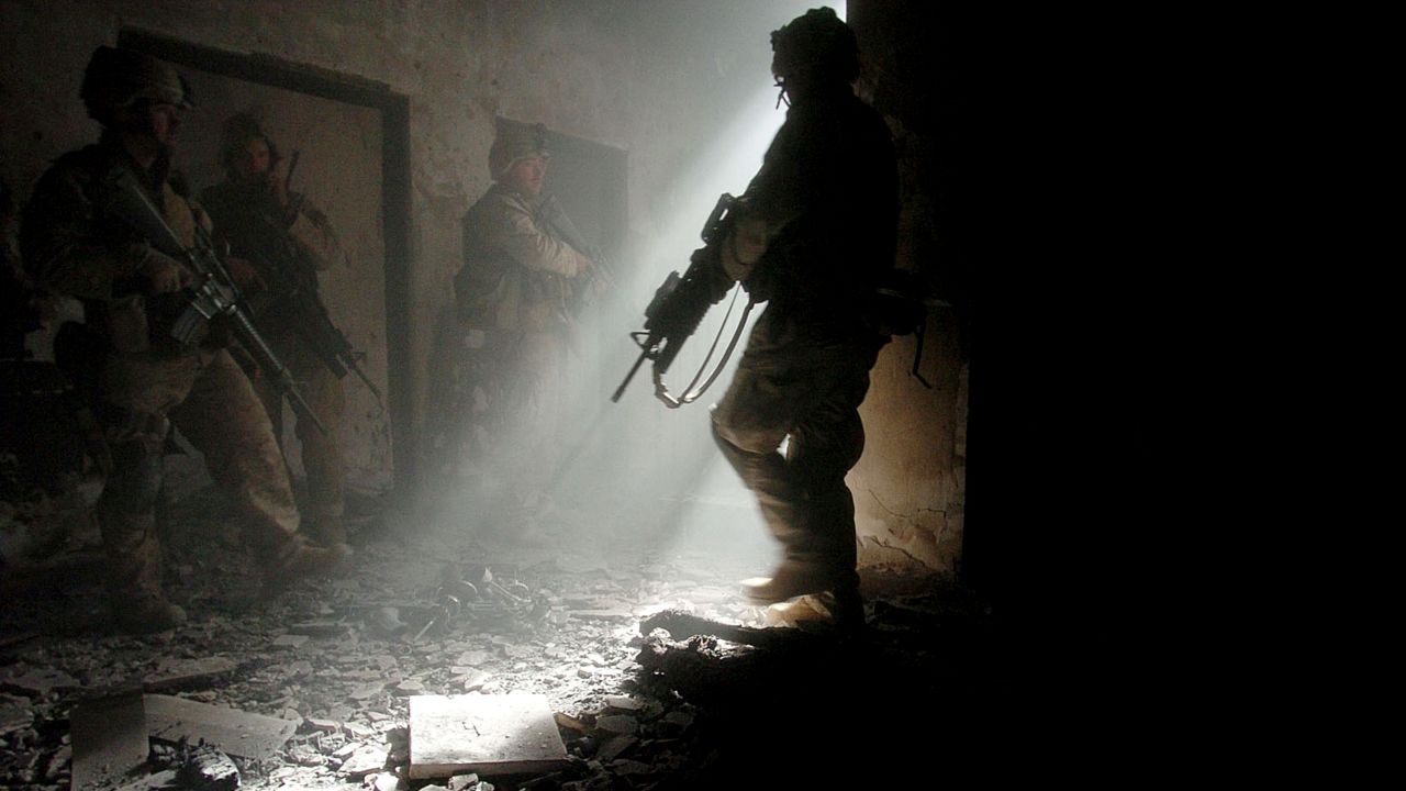Marines clear a home in Fallujah after four insurgents staged a bloody counterattack, killing one American and wounding many others, on November 23, 2004.