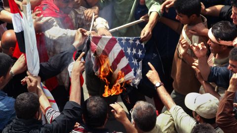 Iraqi Shiite demonstrators loyal to cleric Muqtada al-Sadr burn a U.S. flag during a protest in Baghdad on April 9, 2005. The rally was called on the second anniversary of the fall of Baghdad, with protesters demanding an end to the U.S. military presence in Iraq.