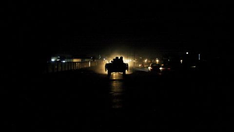 A British armored vehicle is illuminated by traffic during a patrol of Basra on July 27, 2006.