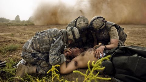 Medics treat Army Spc. Jose Callazo after his mine-detecting vehicle hit a buried IED in Hawr Rajab on August 4, 2007.