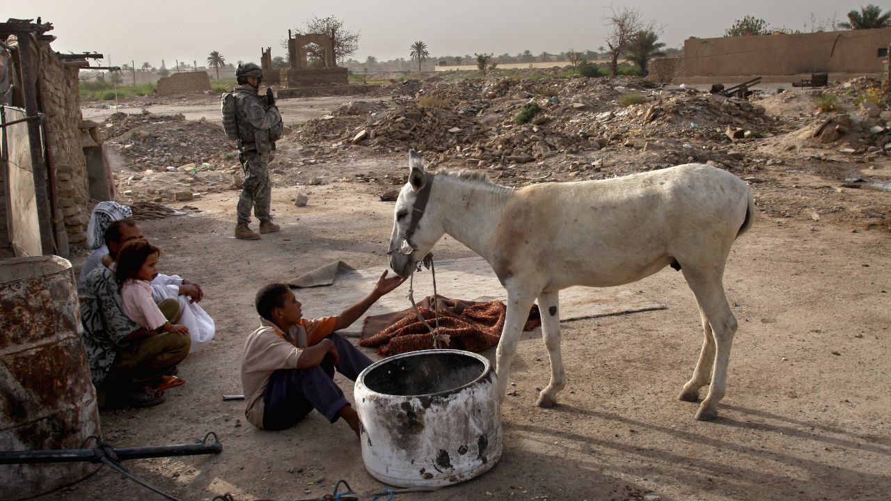 An American soldier prepares to search a home for illegal weapons in the Hurriyah neighborhood of Baghdad on September 9, 2007.
