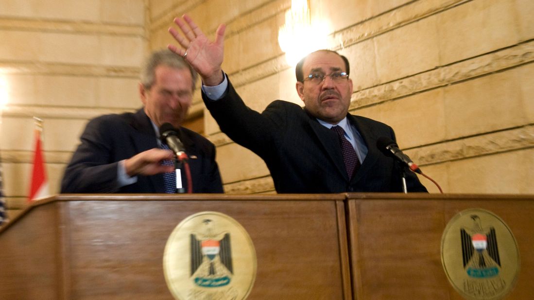 Iraqi Prime Minister Nuri al-Maliki tries to block a shoe thrown at President Bush during a news conference in Baghdad on December 14, 2008. The Iraqi journalist who threw the shoes missed the president but could be heard yelling in Arabic, "This is a farewell ... you dog!"