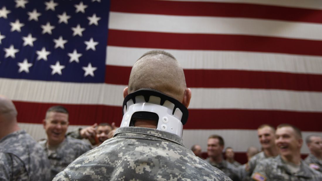 Pfc. Jeremy Tomlinson, who was wounded a year before in Iraq, waits with fellow soldiers to greet returning comrades in Fort Carson, Colorado, on January 28, 2008. About 3,800 soldiers were coming home after a 15-month tour of duty.