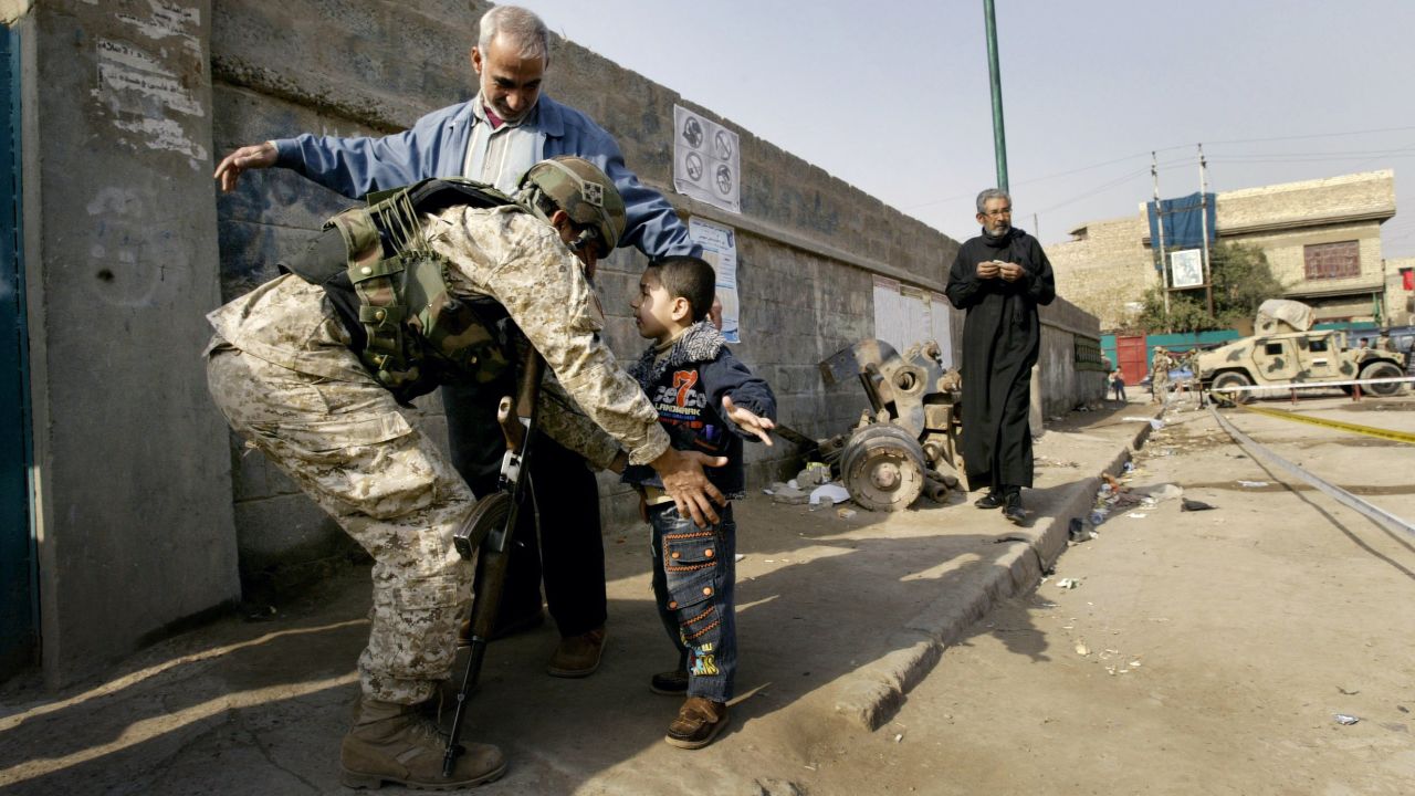 An Iraqi soldier searches a boy at a polling station in Baghdad on January 31, 2009. People across the country voted to fill 440 provincial council seats.