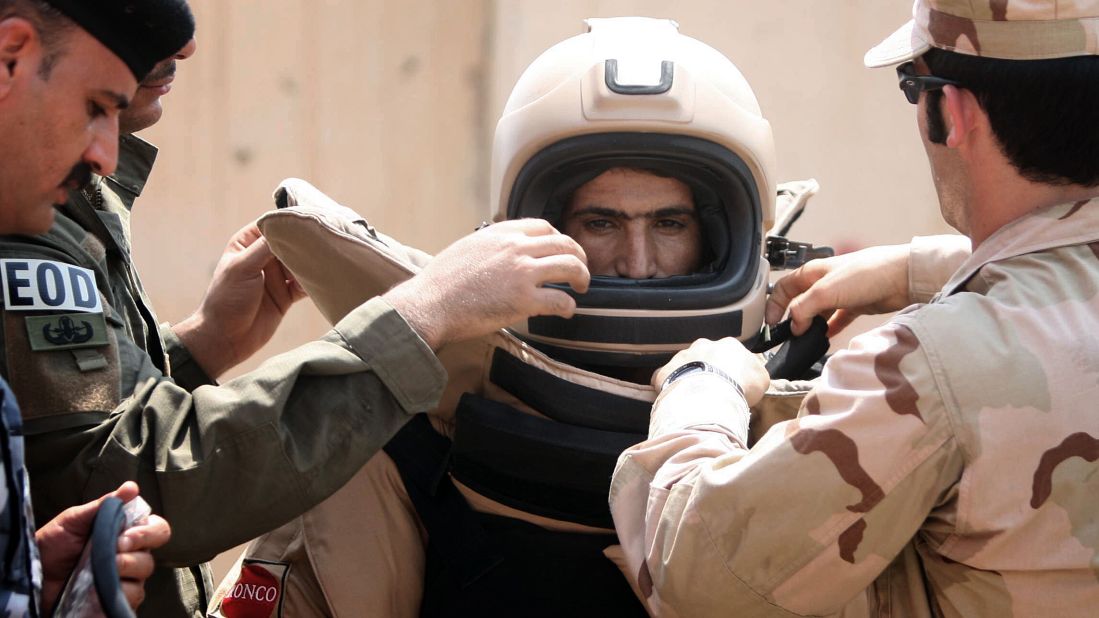 An Iraqi explosives expert gets into a special suit for bomb disposal during a training session organized by his U.S. counterparts at the Warhorse military base near the restive city of Baquba on August 17, 2010.