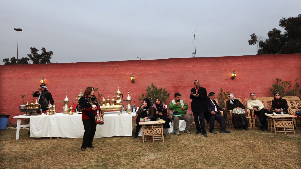 Iraqis gather at a women's art exhibition in a posh Baghdad neighborhood on December 14, 2011.