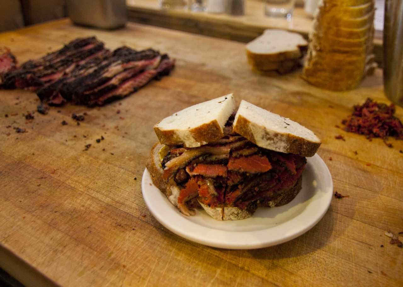 Introduced at Jewish delis in Montreal, smoked meat draws comparisons to pastrami. From a different cut of beef, Montreal smoked meat is spiced differently. Pictured: Montreal smoked meat from Mile End Delicatessen in Brooklyn.