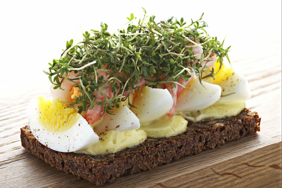 A traditional open-faced sandwich from Denmark, smørrebrød is made with a butter base on dark rye bread. Toppings might include smoked salmon or roast beef with arugula and horseradish crème fraiche. Pictured: eggs with freshly peeled shrimp smørrebrød from Aamanns-Copenhagen in New York.