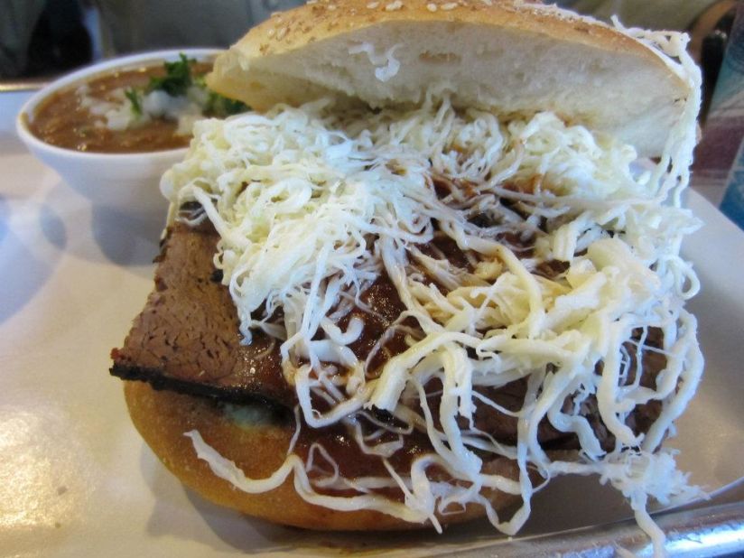 Served on a large, crusty egg bun covered in sesame seeds, the Mexican cemita can be filled with options including fried pork loin. Toppings include avocado, chipotle peppers, Oaxacan cheese and an herb called papalo. Pictured: cemita from Cemitas Puebla in Chicago