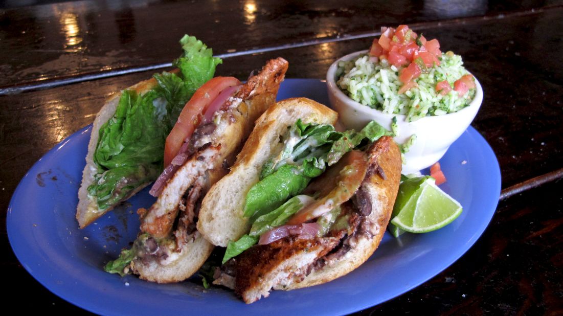 The Mexican torta is typically served on a crusty, football-shaped roll. Popular tortas include fillings such as carne asada or chorizo accompanied by tomato, onions, jalapeño and avocado. Pictured: Achiote-citrus pork torta from Torta-Landia! in Portland, Oregon.