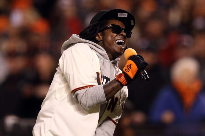 Lil Wayne sings "Take Me Out to the Ball Game" during the seventh-inning stretch as the San Francisco Giants took on the St. Louis Cardinals during the National League Championship Series in 2012.