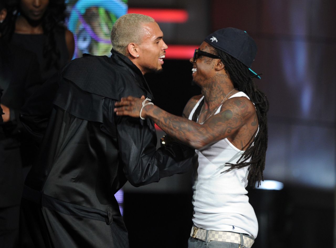 Singer Chris Brown, left, and Lil Wayne embrace onstage during the 2011 BET Awards.