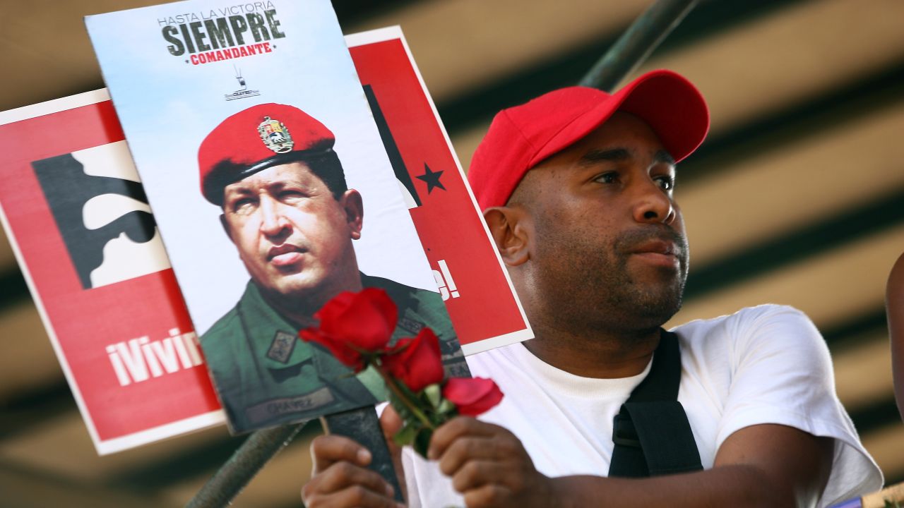 Supporters watch as the coffin with the remains of late Venezuelan President Hugo Chavez is taken from the Military Academy to former 4 de Febrero barracks in Caracas, on March 15, 2013. 