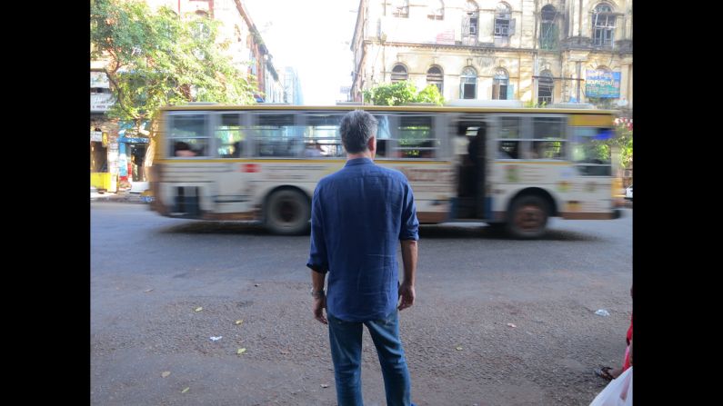 Bourdain stands on the streets of Yangon.