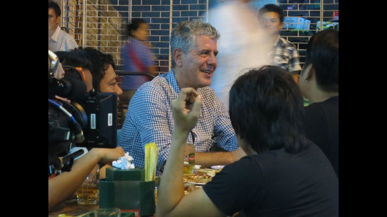 Bourdain sits down with a band, Side Effect, at a barbecue restaurant, Kaung Myat, in Yangon.