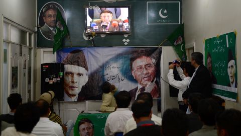 Activists of the All Pakistan Muslim League (APML) watch former president Musharraf give a press conference March 1, 2013.