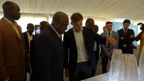 Italian architect Paolo Brescia (center) showcases the Hope City design to Ghanaian president John Mahama, standing next to him.