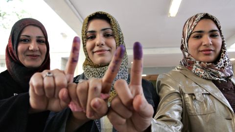 Iraqi women show off their ink stained fingers after voting in the provincial elections in central Baghdad on 31 January 2009.  
