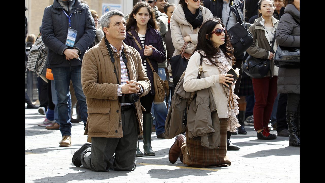 A man and woman pray in St. Peter's Square on March 19.