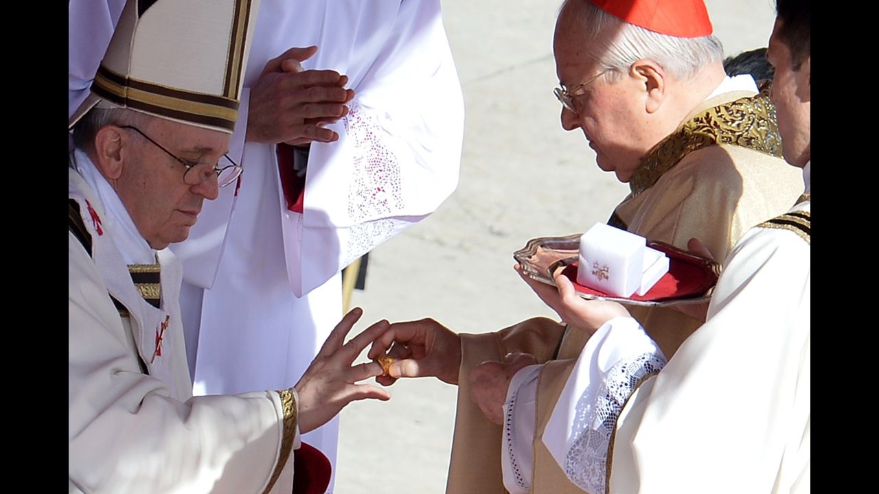Italian cardinal Angelo Sodano puts the fisherman's ring on Pope Francis' finger during the inauguration Mass. The ring represents the pope's role in spreading the Gospel.