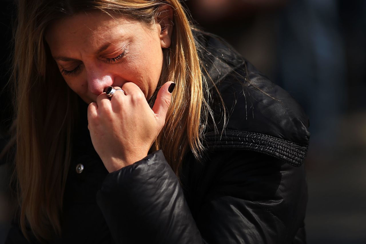 A woman prays during the inauguration Mass at St. Peter's Square.
